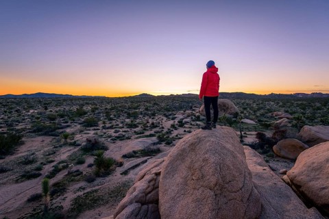 Young woman standing on granite rocks