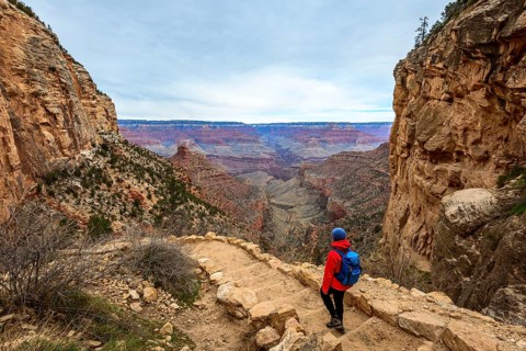Young woman descending on footpath down into Grand Canyon