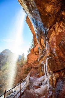 Waterfall falls from overhanging rock
