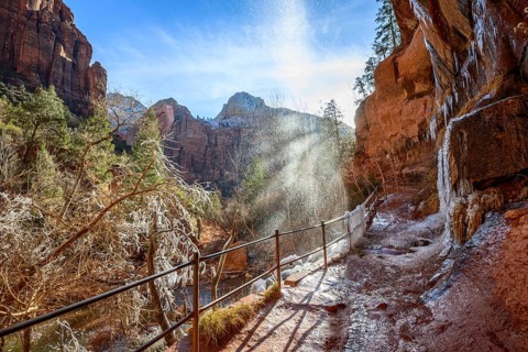 Waterfall falls from overhanging rock