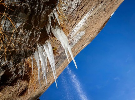 Icicles hanging on rock face