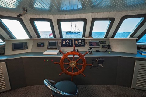Navigation bridge with view of sailing ship