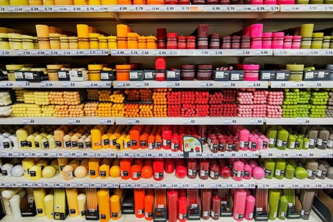 Shelves with coloured candles in supermarkets