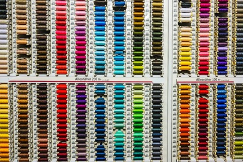 Colorful spools with sewing thread in many colors in a department store