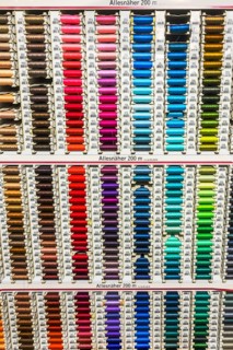 Colorful spools with sewing thread in many colors in a department store