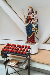 Madonna figure with baby Jesus and sacrificial candles
