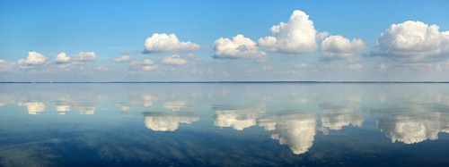 Clouds are reflected in the calm water