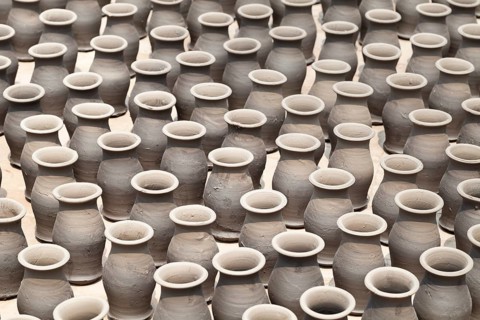 Rows of pots drying in the sun in potters square