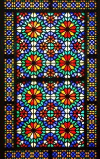 Ornamental colourful window at Bagh-e Dolat Abad