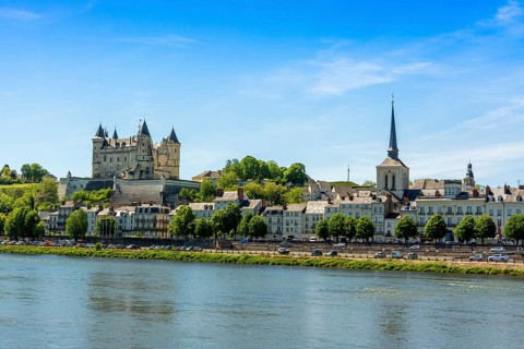 City view with Chateau de Saumur and Saint Pierre church on the banks of the Loire river
