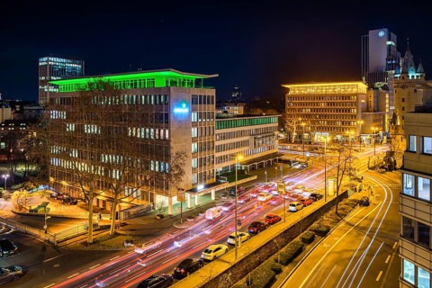 Illuminated intersection at Eschenheimer Turm with view of Rentenbank and Fleming's Deluxe Hotel Frankfurt-City