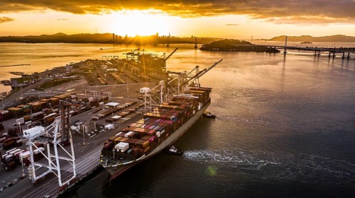 Cargo ship at sunset in the Port of Oakland