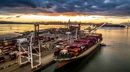 Cargo ship at sunset in the Port of Oakland