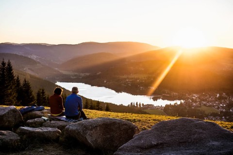 Older couple at Hochfirst with view to Titisee and Feldberg at sunset