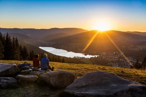 Older couple at Hochfirst with view to Titisee and Feldberg at sunset