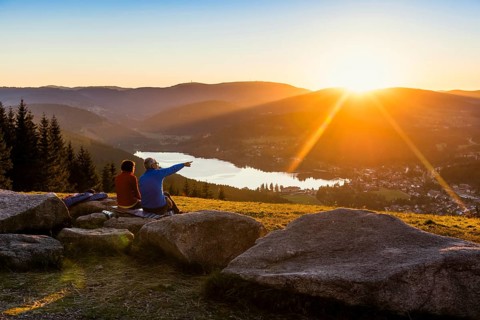 Older couple at Hochfirst with view to Titisee and Feldberg at sunset
