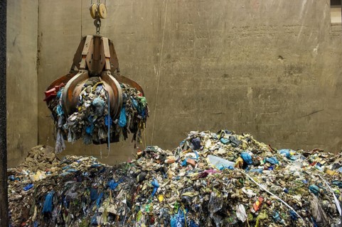 Gripper arm over pile of trash