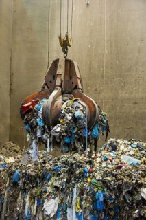 Gripper arm over pile of trash