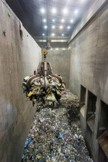Gripper arm over pile of trash