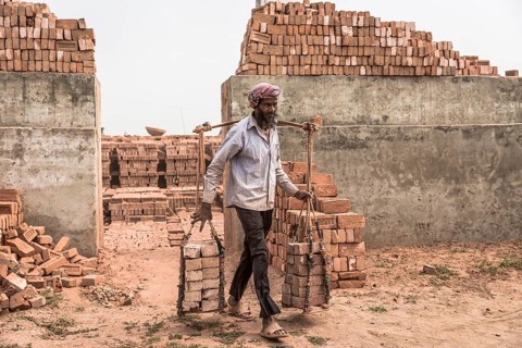 Brickworks worker transports bricks