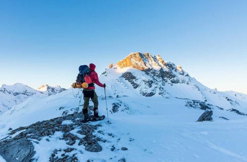 Snowshoe hiker with backpack