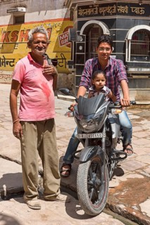 Man and child on motorcycle with older man