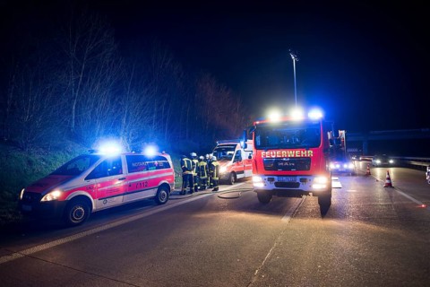 Emergency vehicles in an accident on the highway at night