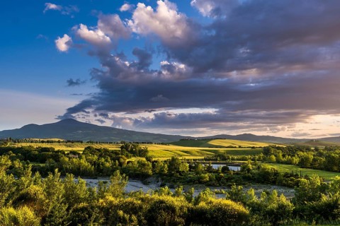 Typical green Tuscan landscape in Val d'Orcia with hills