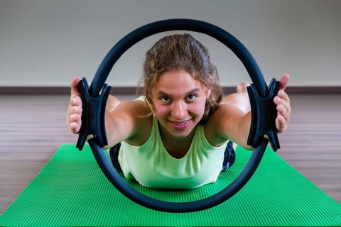 A young woman is training Pilates