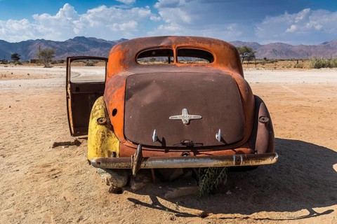 Old car wreck in sand