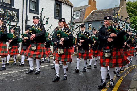 Bagpipers playing instruments in a parade
