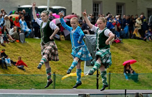 Girls dancing in kilts at a folk dance competition