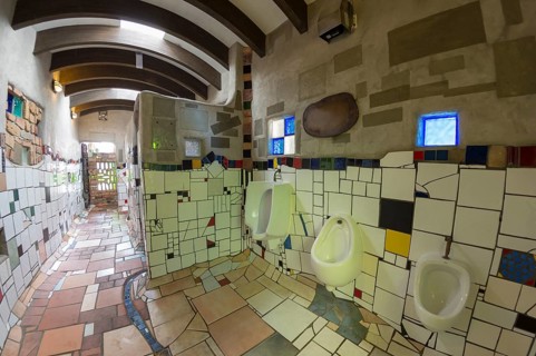 Urinal with ceramic tiles in the public toilet of the artist and architect Friedensreich Hundertwasser