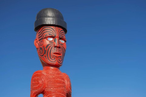 Artfully carved traditional statue of Maori made of wood