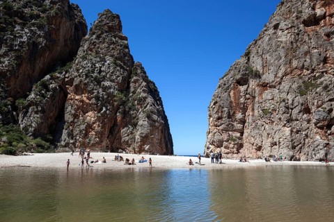 People on the beach in the gorge Torrent de Pareis