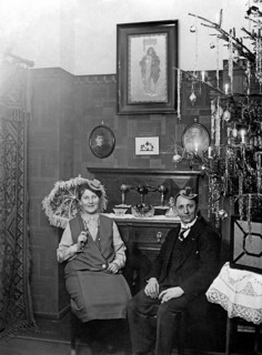 Couple celebrates New Year's Eve in the living room next to the Christmas tree