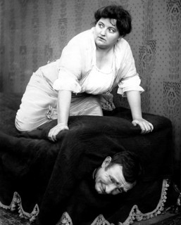 Woman hiding man in sofa