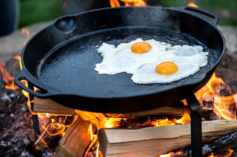Fried eggs in a pan over an open fire