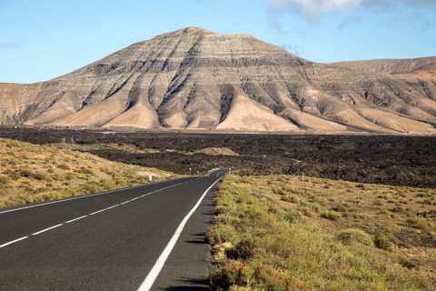 Road leading towards volcanic landscape