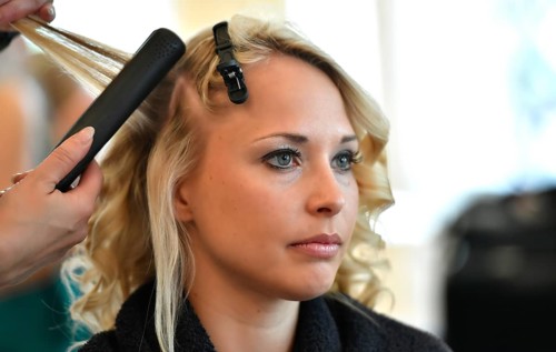 Young woman being styled at the hair salon