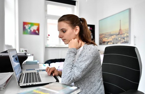 Student at desk with a laptop