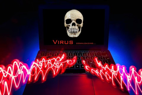 Laptop with skull and crossbones on screen