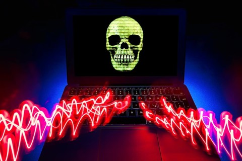 Laptop with skull and crossbones on screen
