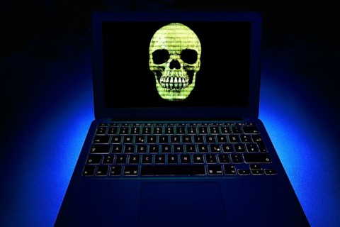 Laptop with skull and crossbones on screen