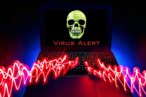 Laptop with skull and crossbones on screen