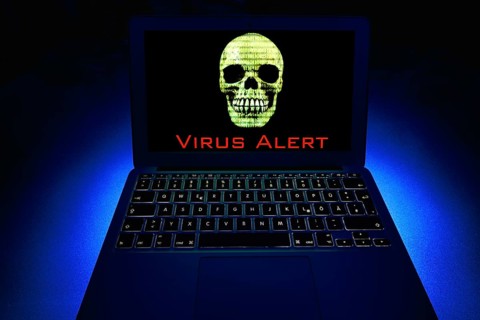 Laptop with skull and crossbones on screen