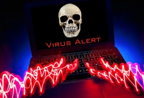 Laptop with skull and crossbones on screen