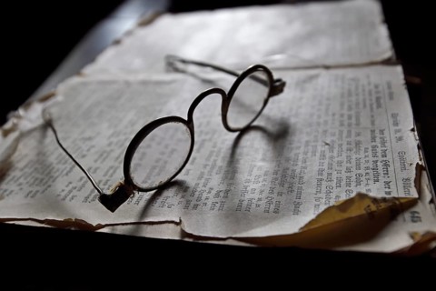 Old spectacles on historic book