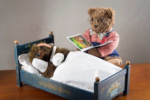Sick Teddy Bear with bandaged paws and head