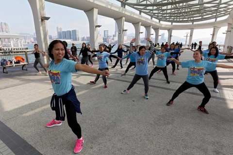 Southeast Asian women dancing Zumba on pier